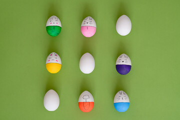 Top view of composition with easter eggs on green background 
