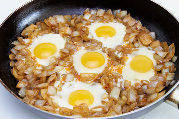 Fried eggs in a large frying pan