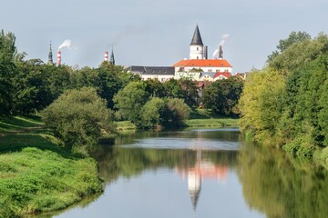 Obraz premium Wiew of the tower and chimneys of the city from the bridge over the Becva River. Prerov. Central Moravia. Czechia. Europe. 