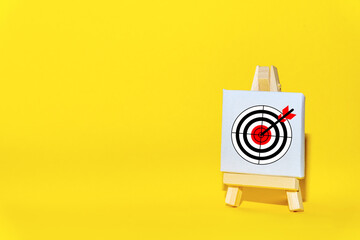 Sign stand with an arrow in the target  on a yellow background hit exactly on center. Tactics of...