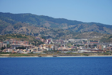 Fototapeta na wymiar Messina harbour town aerial panoramic view from sea, Sicily, Italy
