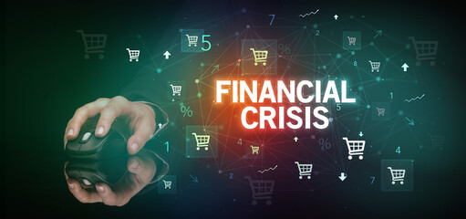 hand holding wireless peripheral with FINANCIAL CRISIS inscription, online shopping concept