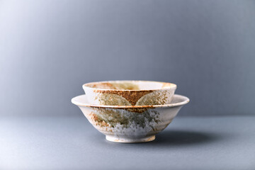 Traditional ceramic bowls on paper background. Copy space.