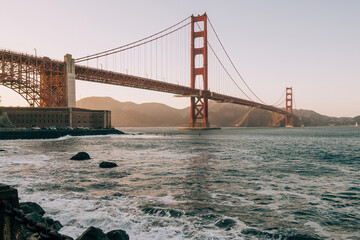 Beautiful view of famous Golden Gate Bridge in San Francisco in the rays of the setting sun