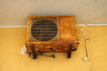 Old rusted air conditioning outdoor unit by salted water, refrigeration maintenance concept