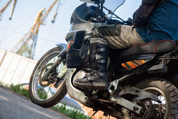 Fototapeta na wymiar A motorbiker is sitting on his motorcycle close up.