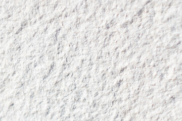 Texture of rough surface of a white stone wall close-up
