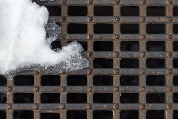 ice and snow on the drain grate