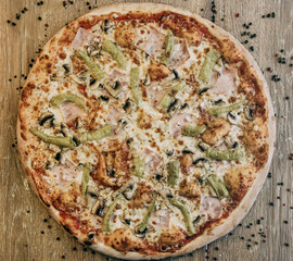 Large pizza with ham and porcini mushrooms. Pizza ingredients. pizza with rosemary sprigs and sauce