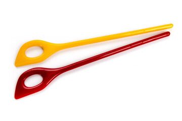 two colorful kitchen slot stirring spoons isolated on white
