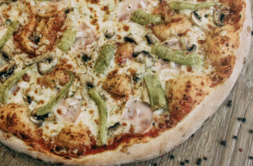 Large pizza with ham and porcini mushrooms. Pizza ingredients. pizza with rosemary sprigs and sauce