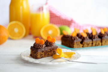 Chocolate orange carrot cake on white saucer