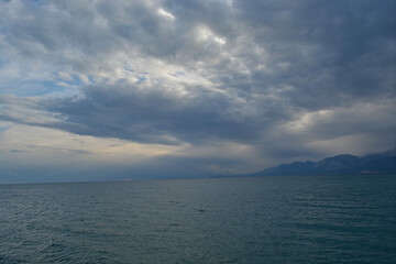 sea and mountains with foggy weather