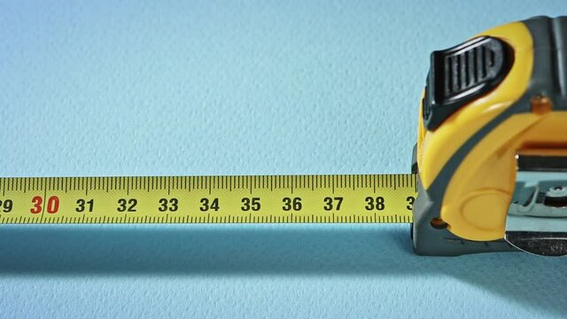 yellow construction measure tape roulette opening slow motion