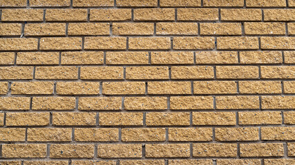 The texture brown yellow decorative brick wall, background.