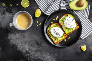 Sandwich with avocado and Poached Egg. Wholemeal Bread Toast sliced avocado and egg with cup of coffee for healthy breakfast or snack, copy space.