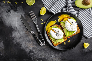 Sandwich with avocado and Poached Egg. Wholemeal Bread Toast sliced avocado and egg. healthy breakfast or snack, top view