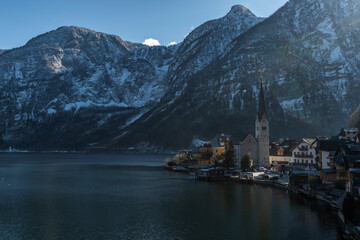 Hallstatt old town in winter blue day with church with tower in Austria