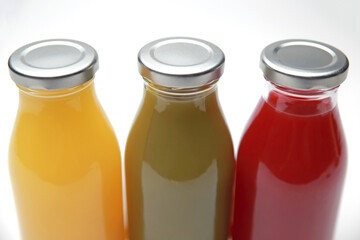 Bottles of healthy, colorful, homemade, cold pressed fresh fruit and vegetable juices; color studio photograph, No. 03.