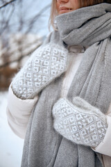 Hands in Knitted Mittens. Winter lifestyle. Wearing Stylish Warm