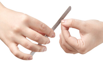 A woman does a manicure at home and uses a nail file to remove old gel polish from her nails....
