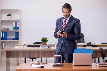 Young man businessman employee sitting in the office
