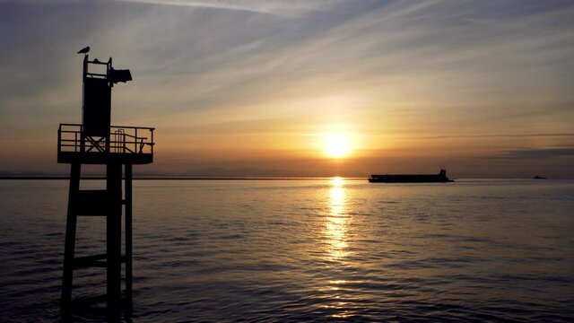 Ship passing Garry Point Park Viewpoint in sunset time. Richmond, BC, Canada
