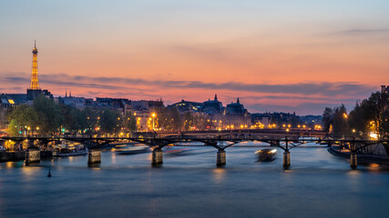 Fototapeta premium Pedestrian bridge (Pont des Arts) over Seine river and historic buildings of Paris France