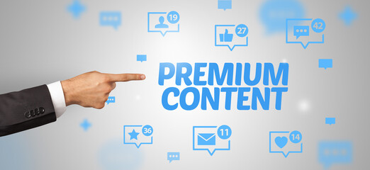 Close-Up of cropped hand pointing at PREMIUM CONTENT inscription, social networking concept