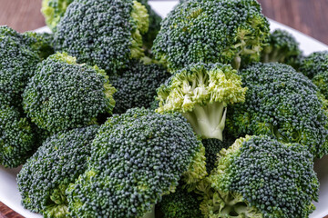  A lot of broccoli for diet and healthy eating. Fresh green broccoli on a   table.Broccoli vegetable is full of vitamin.Vegetables for diet and healthy eating.Organic food.