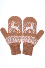 Warm woolen knitted mittens isolated on white background. Brown