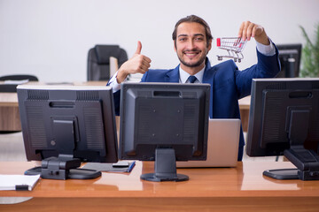 Young male employee in ecommerce concept