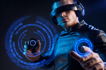 Man on dark virtual reality background. Guy using VR helmet. Augmented reality, future technology,...