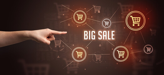 Obraz premium Close-Up of cropped hand pointing at BIG SALE inscription, online shopping concept