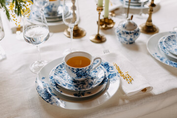 Blue vintage porcelain tea set on a table at a restaurant.
