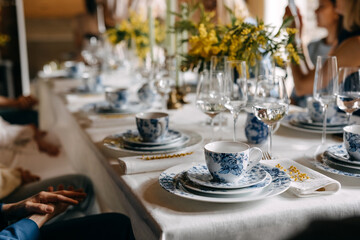 Table setting with vintage porcelain cups of coffee and plates.