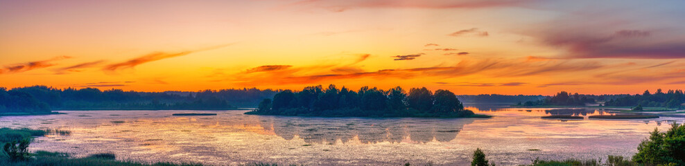 Obraz premium Beautiful landscape with colorful sunset over forest lake