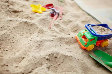 Fototapeta na wymiar Sandbox outdoor. Children's sandbox with various toys for the game