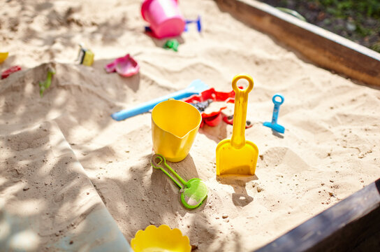 Sandbox outdoor. Children's wooden sandbox with various toys for the game