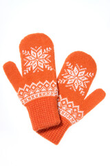 Warm woolen knitted mittens isolated on white background. Orange