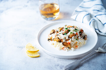 Mussel rice with pepper and parsley in a plate