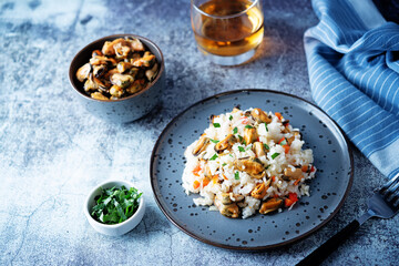 Mussel rice with pepper and parsley in a plate
