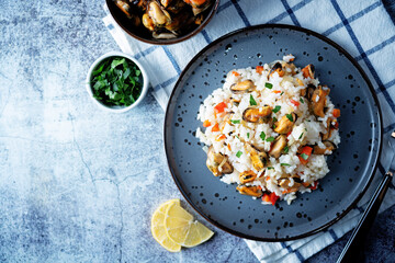 Mussel rice with pepper and parsley in a plate