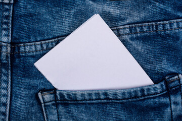 A sheet of white paper in a jeans pocket.