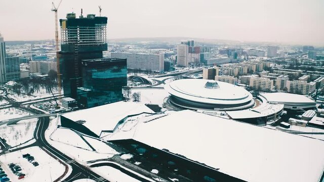 Katowice, Poland snowy winter cityscape drone panorama: modern urban business city center with Spodek sports music hall, KTW office skyscrapers construction and Centrum Kongresowe in Silesia capital