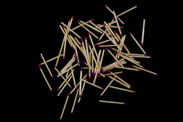 Matches are scattered on a black table.