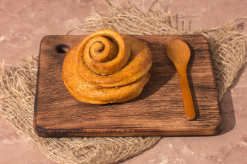 Freshly baked cinnamon bun stuffed with spices and cocoa . Sweet homemade cakes.