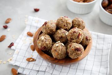 Close-up of homemade dried fruit, nuts and oatmeal balls. Energy balls in a wooden bowl. Horizontal orientation