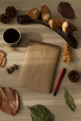 A cup of coffee , notebook ,leaves with wool sweater for concept.