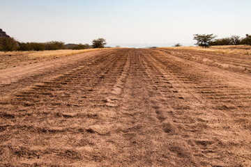 Fototapeta premium Road trip in Damaraland, Namibia - close up of a washboard gravel road